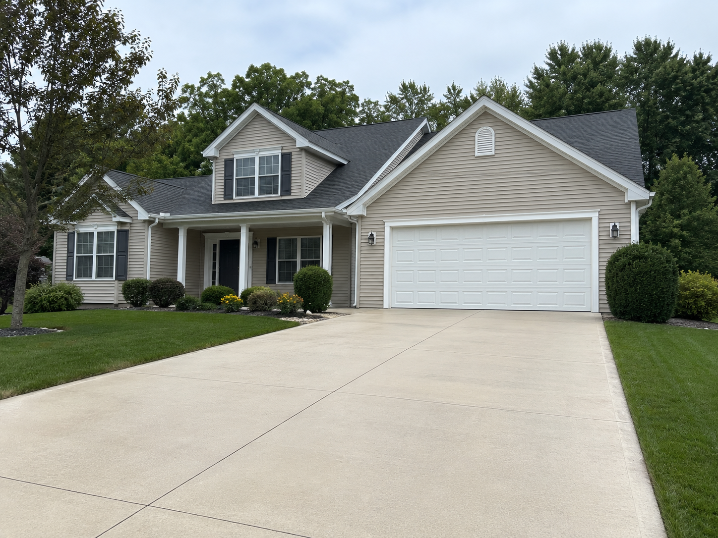 Clean concrete driveway after professional pressure washing in Traverse City MI by Anchor Pro Wash